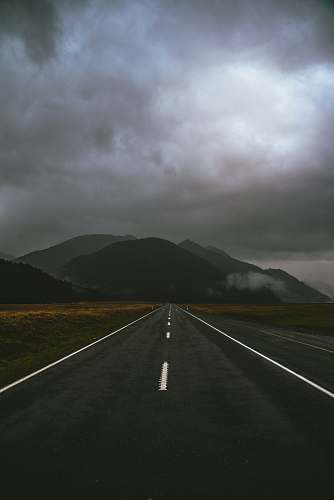 grey gray road under cloudy sky milford sound highway
